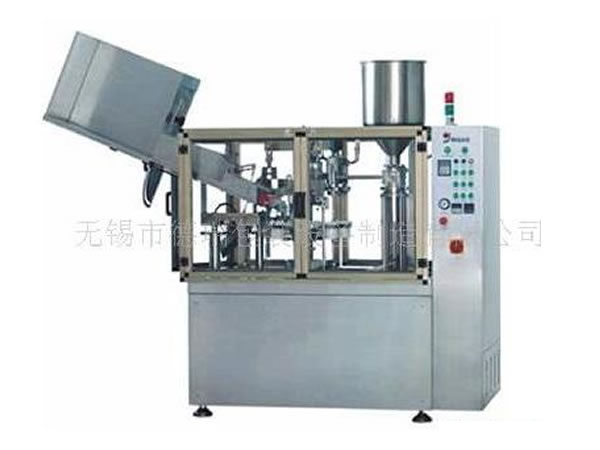 Tube filling and sealing machine